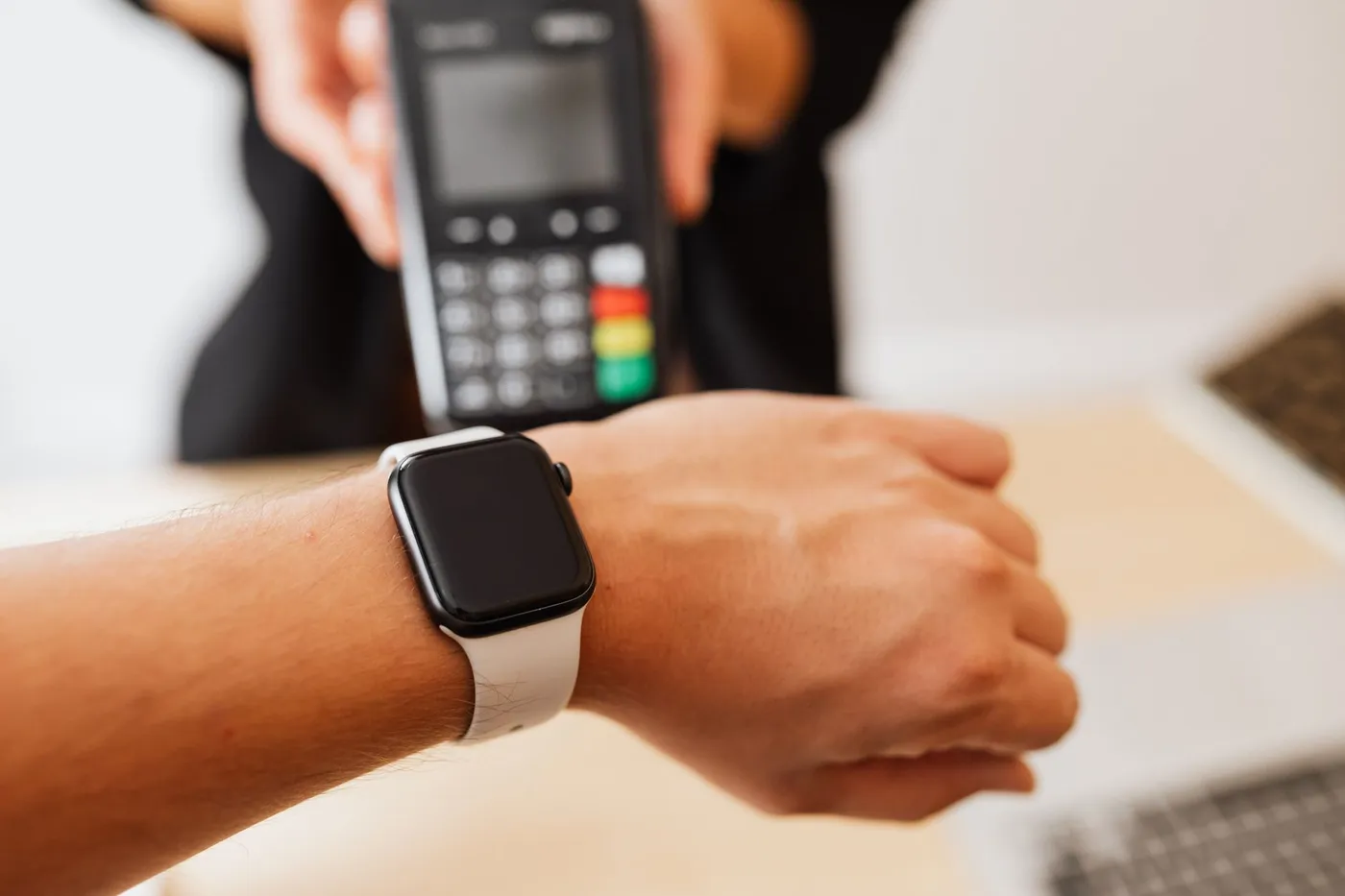Customer paying with a smartwatch on a contactless card terminal